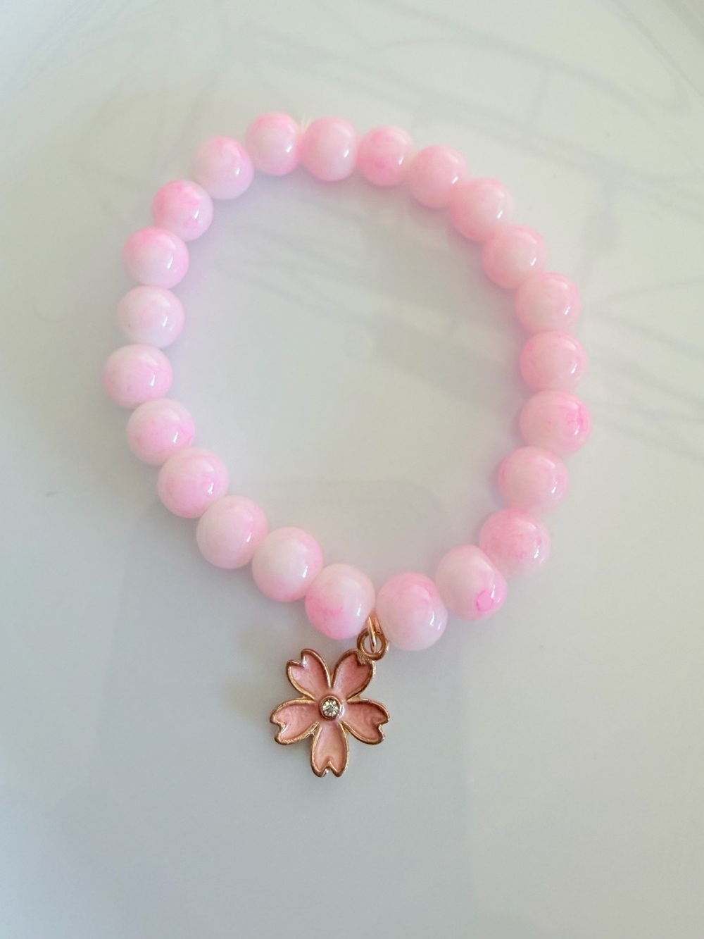 Pink Beaded Stretch Bracelet with Gold Cherry Blossom Charm
